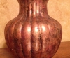 Black plastic vase transformed to coppery tones